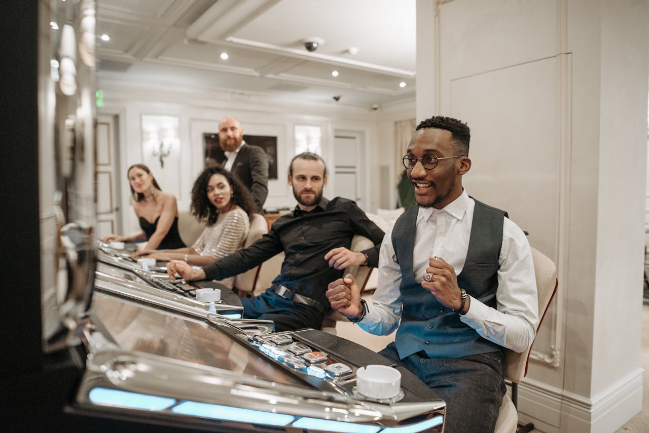 Diverse group of adults enjoying a vibrant casino atmosphere with slot machines.